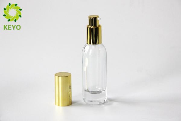 Clear Glass Foundation Bottle 30ml Thick Bottom Type With Gold Aluminium Pump