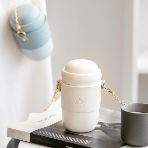 Stylish ceramic water bottle ceramic body gold-toned chain strap trendy design versatile style perfect for everyday