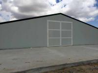 Edificio prefabricado de acero para granja avícola con tragaluces y puertas enrollables