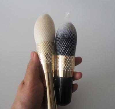 A composição escova redes de empacotamento do cosmético da tampa protetora das luvas da malha