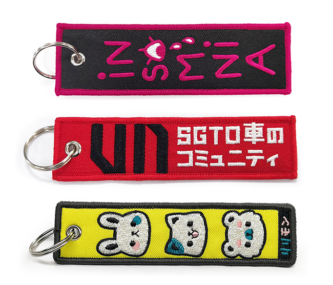 Граница Overlock вышила бирке Keychains двигателя ключевых цепей выдвиженческой