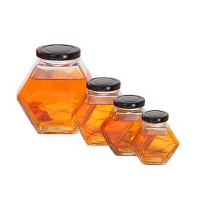 стеклянные опарникы меда 250ml-750ml с крышками, стеклом шестиугольника раздражают ясный цвет