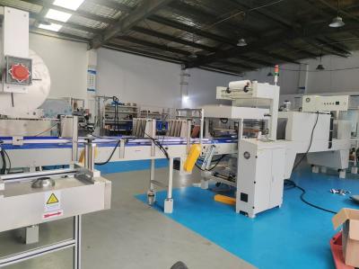 Straight-line heat-shrink packaging machine