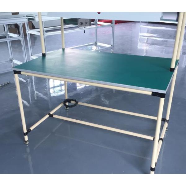 A workbench composed of PE pipes, black metal joints and wooden boards