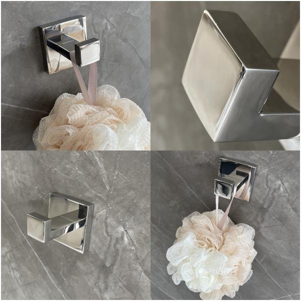 Os ganchos lustrados da veste do banheiro esquadram o gancho de aço inoxidável de toalha fixado na parede