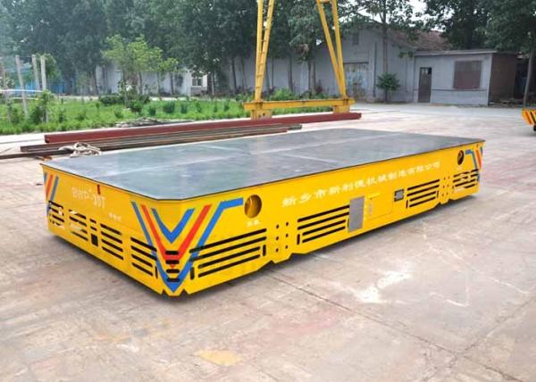Battery operated steerable motorized trackless transfer car on cement floor