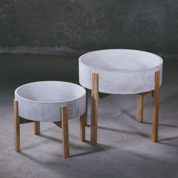 pan shaped concrete flower pot with a four legged wooden stand for flower bed indoor outdoor