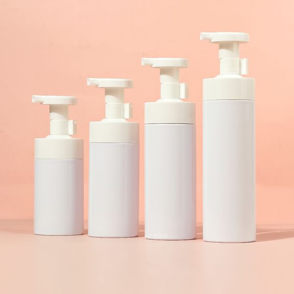 White transparent round foam pump bottle made of high-quality PET material with ergonomic pump head design and multiple capacity options for facial cleanser and body wash
