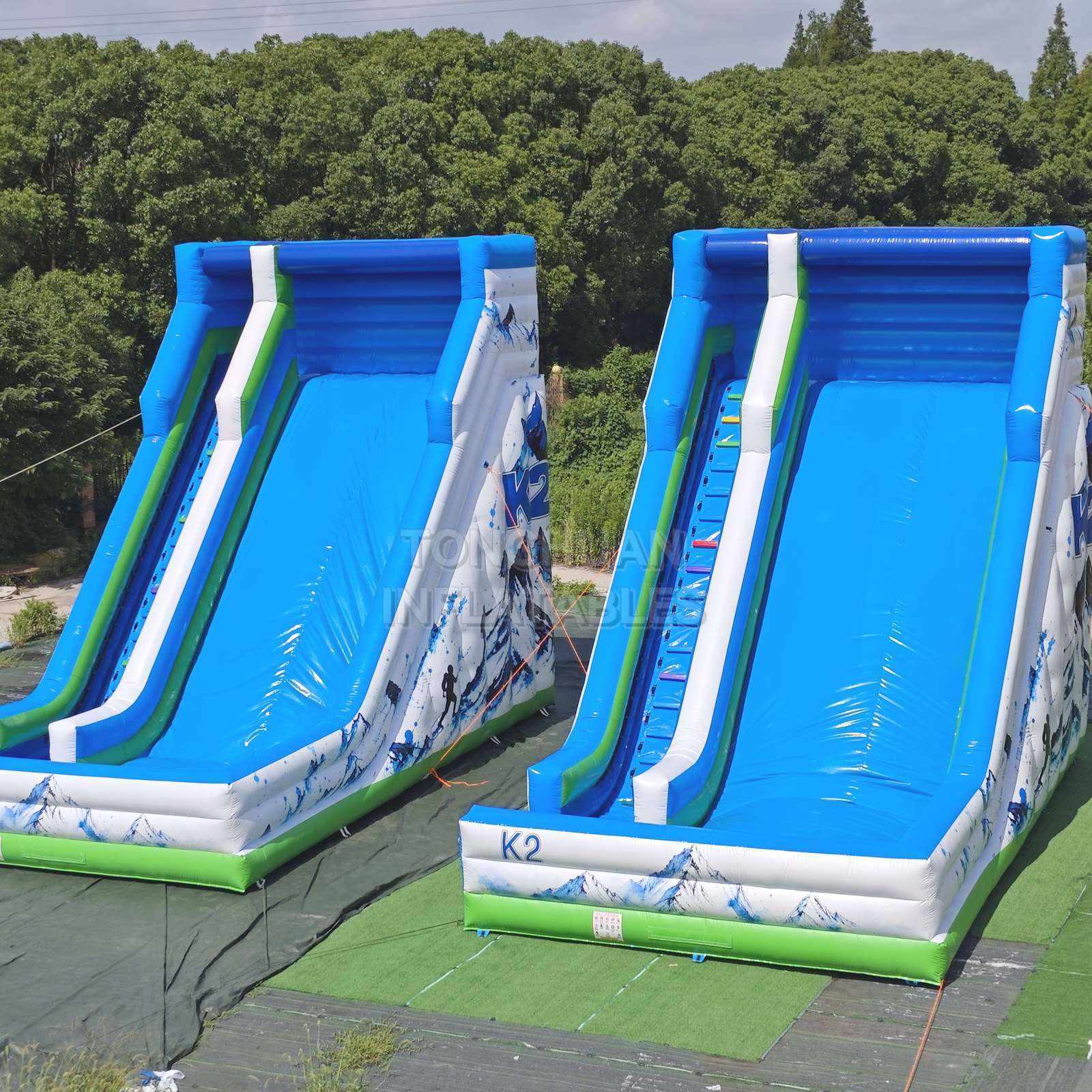 Commercial K2 Double Lane Inflatable Slide with Mountain Graphics High Side Walls and Safety Landing Areas for Parks Events and Rentals