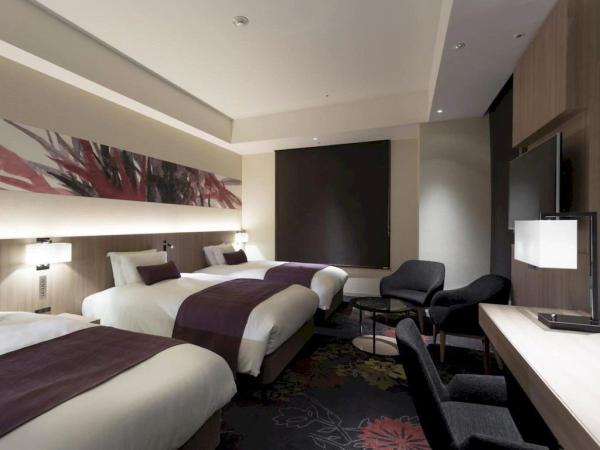 Palmerston North resort hotel inteior design furniture Laminate headboard with nightstand and fabric upholstered sofa