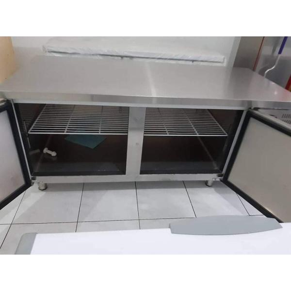 Stainless steel commercial refrigerator workbench in the back kitchen of hotel restaurant