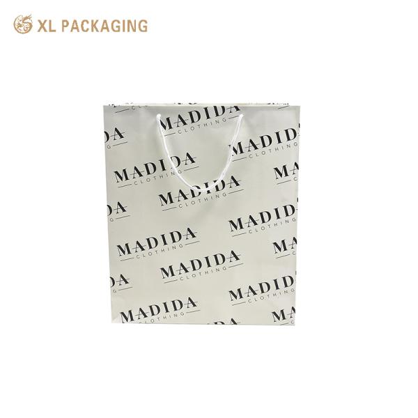 Custom Matte Black Clothing Paper Bags with Reinforced Construction and Full-Surface Logo Printing for Luxury Gift Packaging