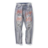 L'OEM a lavé le pantalon fendu unisexe déchiré bleu de jeans avec le denim Manafacturer de graffiti