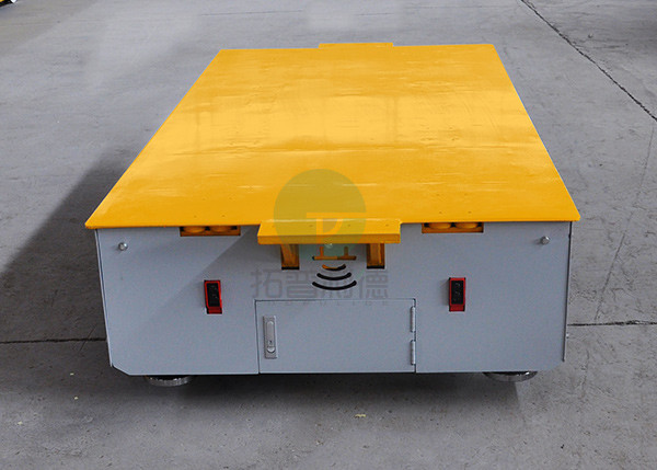 Battery operated steerable motorized trackless transfer car on cement floor