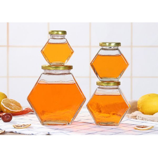 стеклянные опарникы меда 250ml-750ml с крышками, стеклом шестиугольника раздражают ясный цвет