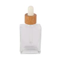 Botella de vidrio transparente de 30 ml 50 ml 100 ml botella de aceite esencial de bambú ecológico
