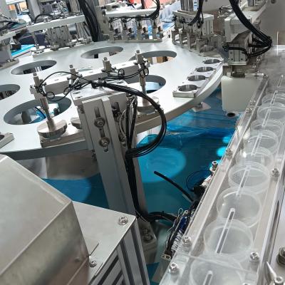 Automated urine cup assembly machine, compatible with feeding elevators and connectable to injection moulding machines, enhances product assembly efficiency and reduces labour requirements.