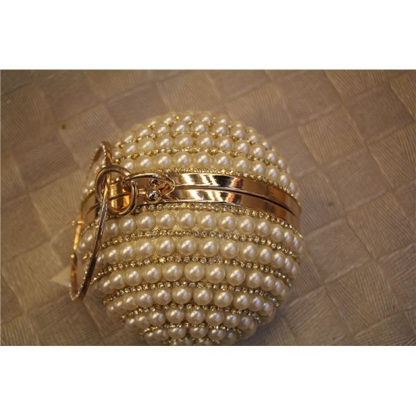 Round high-grade pearls evening bags woman holding a high-end fashion evening bag bride