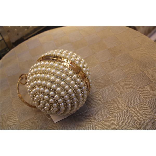 Round high-grade pearls evening bags woman holding a high-end fashion evening bag bride