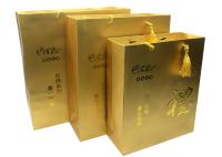 Sacs imprimés de luxe faits sur commande de cadeau de papier d'or avec les poignées de relief de Logo Tassel