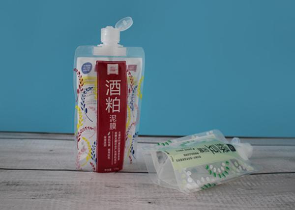 O bico ensaca a parte superior da selagem com as tampas da parte superior da aleta que embalam o creme cosmético