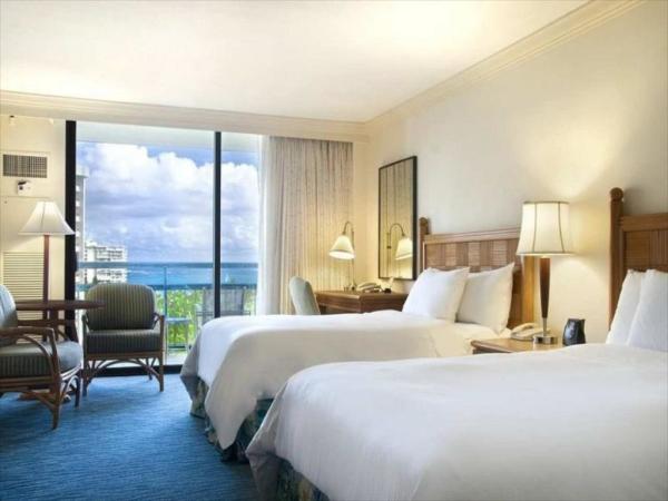 Sakiao interior designer for Hotel guestroom furniture by wood headboard beds with rattan armchairs and TV stand cabinet