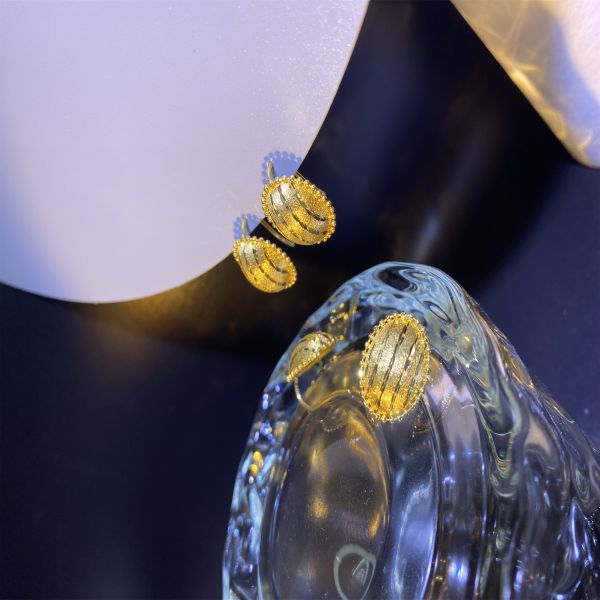 Graciosos aretes de oro de plumería de 18 caratos