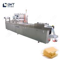 Ligne d'emballage automatique de l'étanchéateur de fromage à film étirable continu thermoformant machine d'emballage sous vide de peau